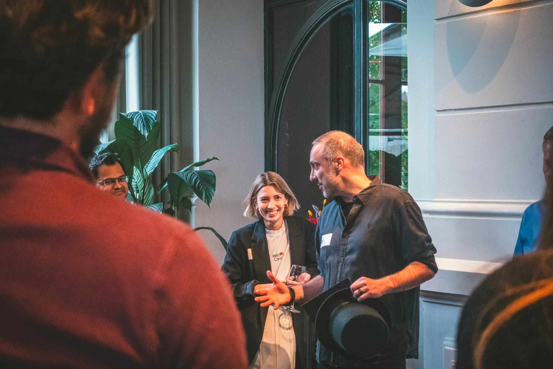 HelloCircle team members in conversation with guests at a community event